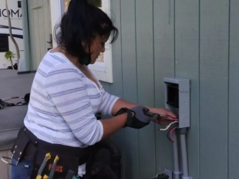 Licensed electrician wiring an exterior subpanel in Country Homes